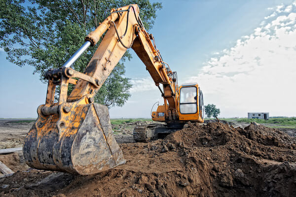 excavator digging a trench for the pipeline